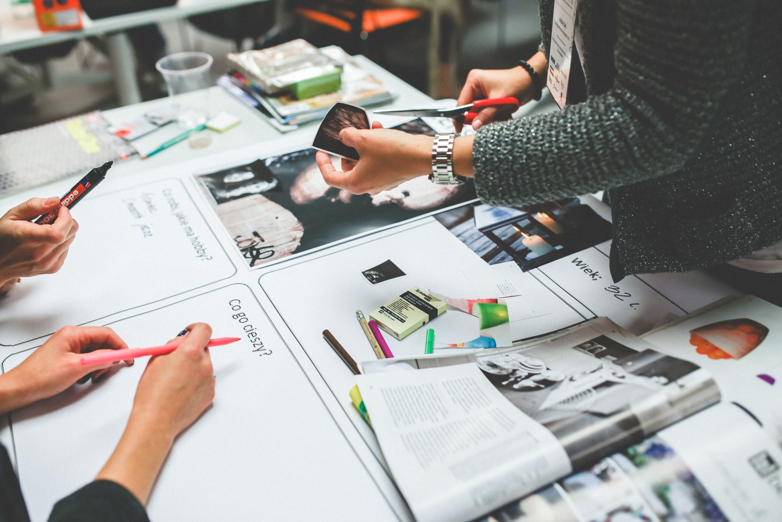 A creative team laying out printed designs